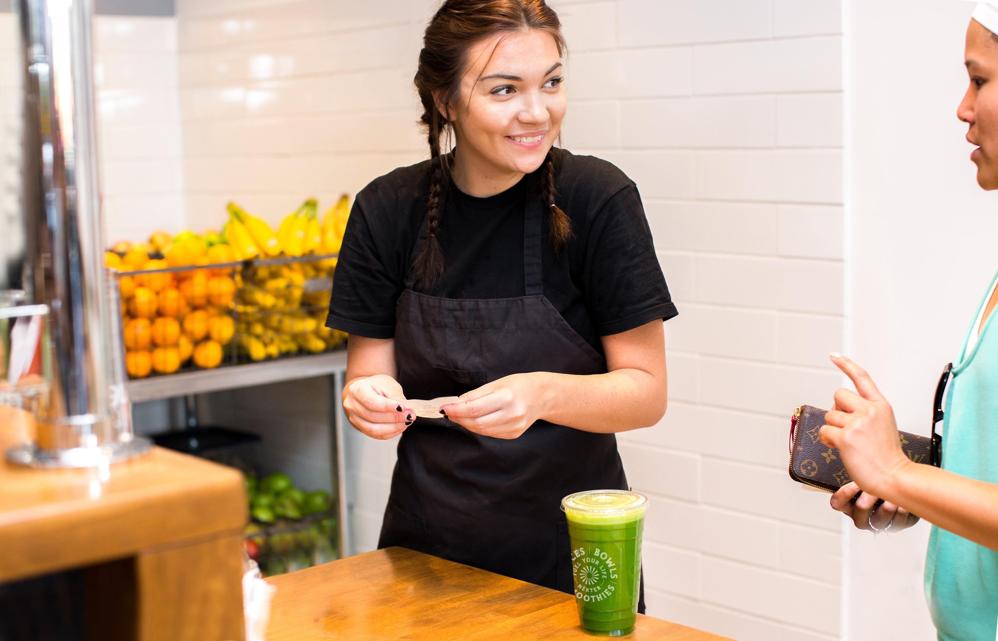 Nekter juicer smiling to a customer