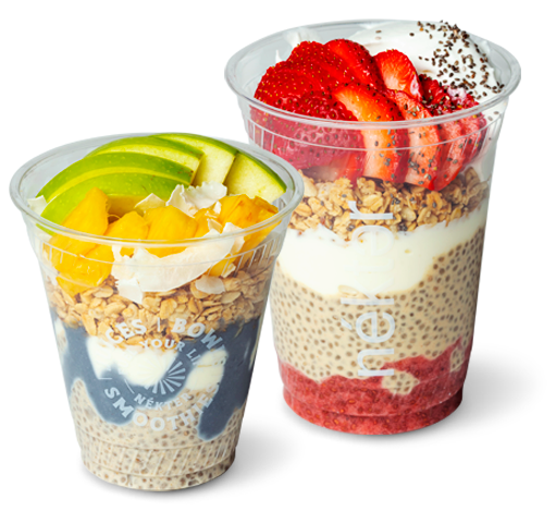 Two Nekter chia parfait cups: one with blue spirulina, granola, mango and apple; another with strawberry, granola and chia.