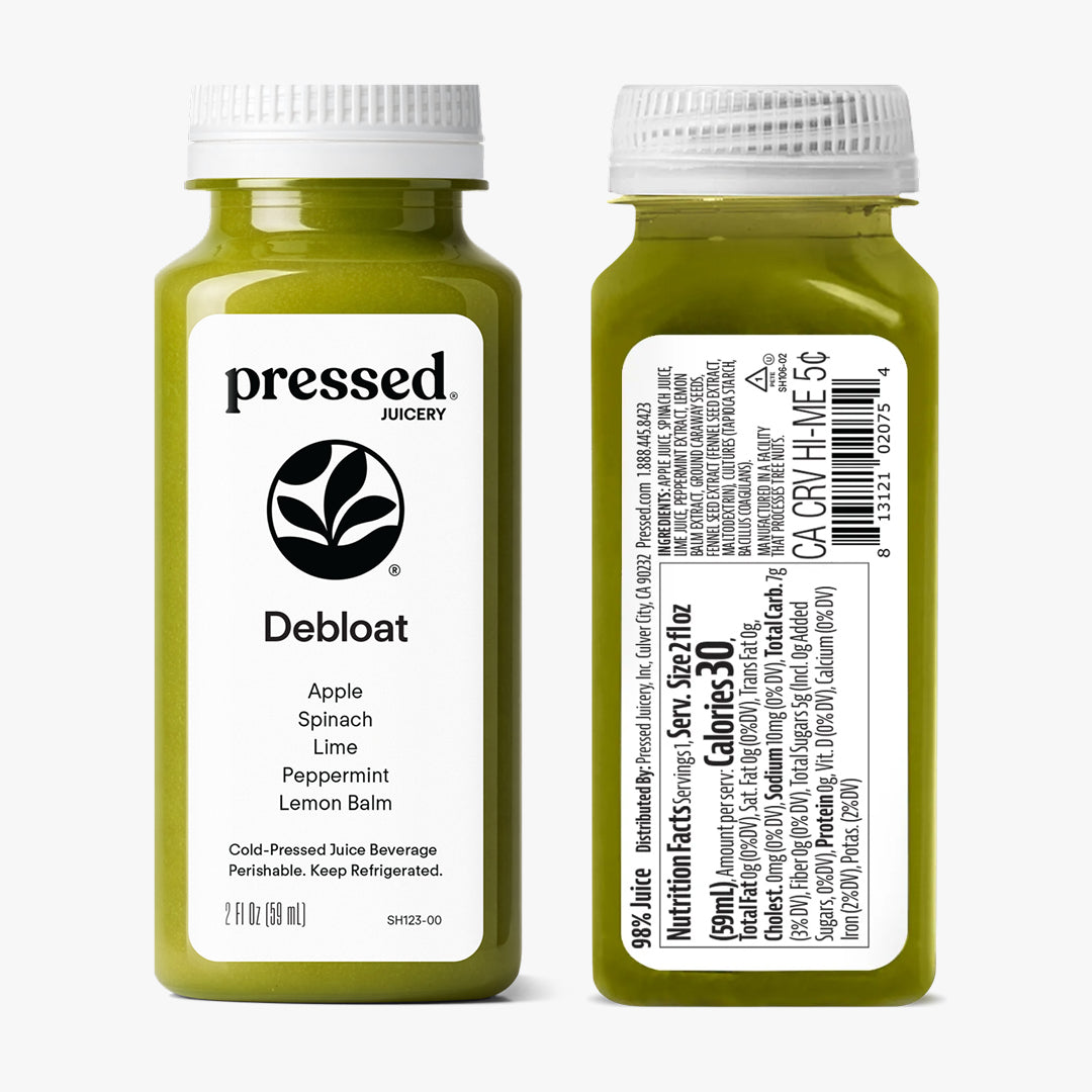 Two bottles of pressed Juicery 'Debloat' juice on a white background