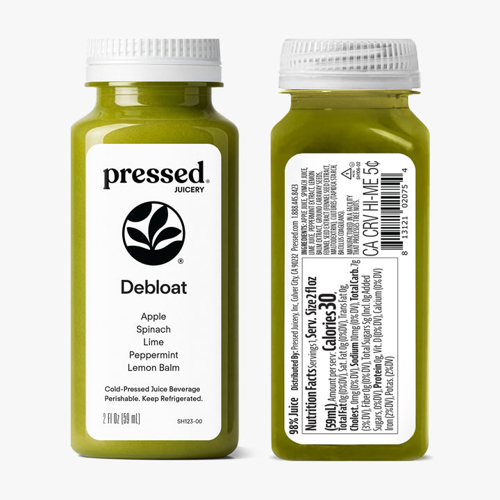 Two bottles of pressed Juicery 'Debloat' juice on a white background