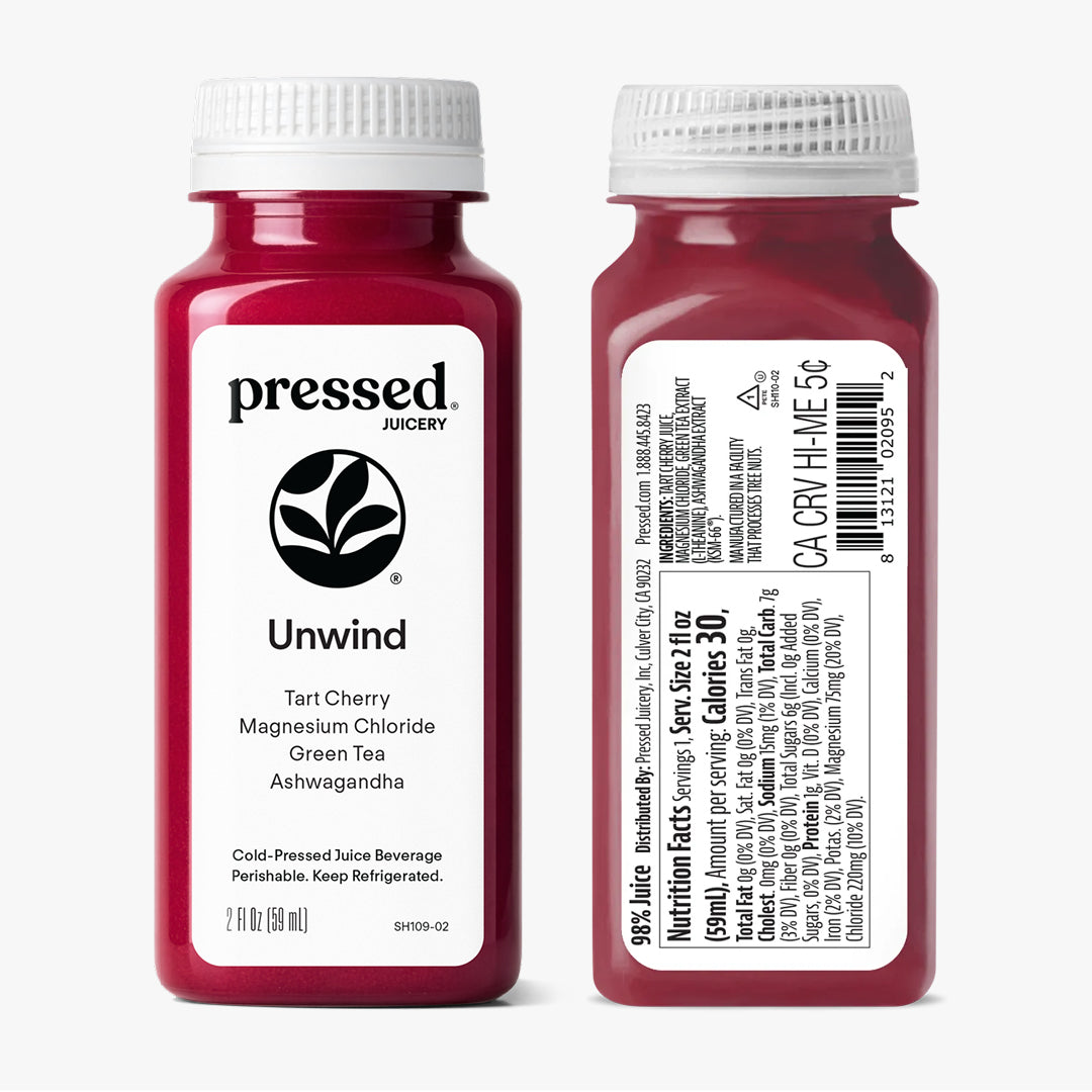 Two bottles of 'Pressed Juicery' Unwind Tart Cherry Magnesium Chloride Green Tea Ashwagandha on a white background.