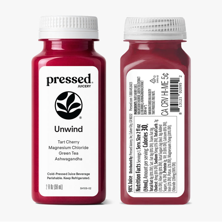 Two bottles of 'Pressed Juicery' Unwind Tart Cherry Magnesium Chloride Green Tea Ashwagandha on a white background.
