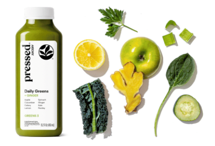 Green juice bottle labeled 'pressed' with fresh fruits and vegetables on a white background