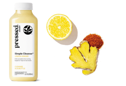 Pressed juice bottle with lemon, ginger, and aloe vera on a white background