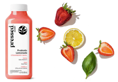 Bottle of 'pressed' probiotic lemonade with strawberries, lemon, and basil leaves on a white background