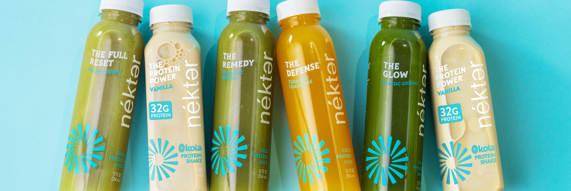 Row of Néktar juice bottles on a blue background