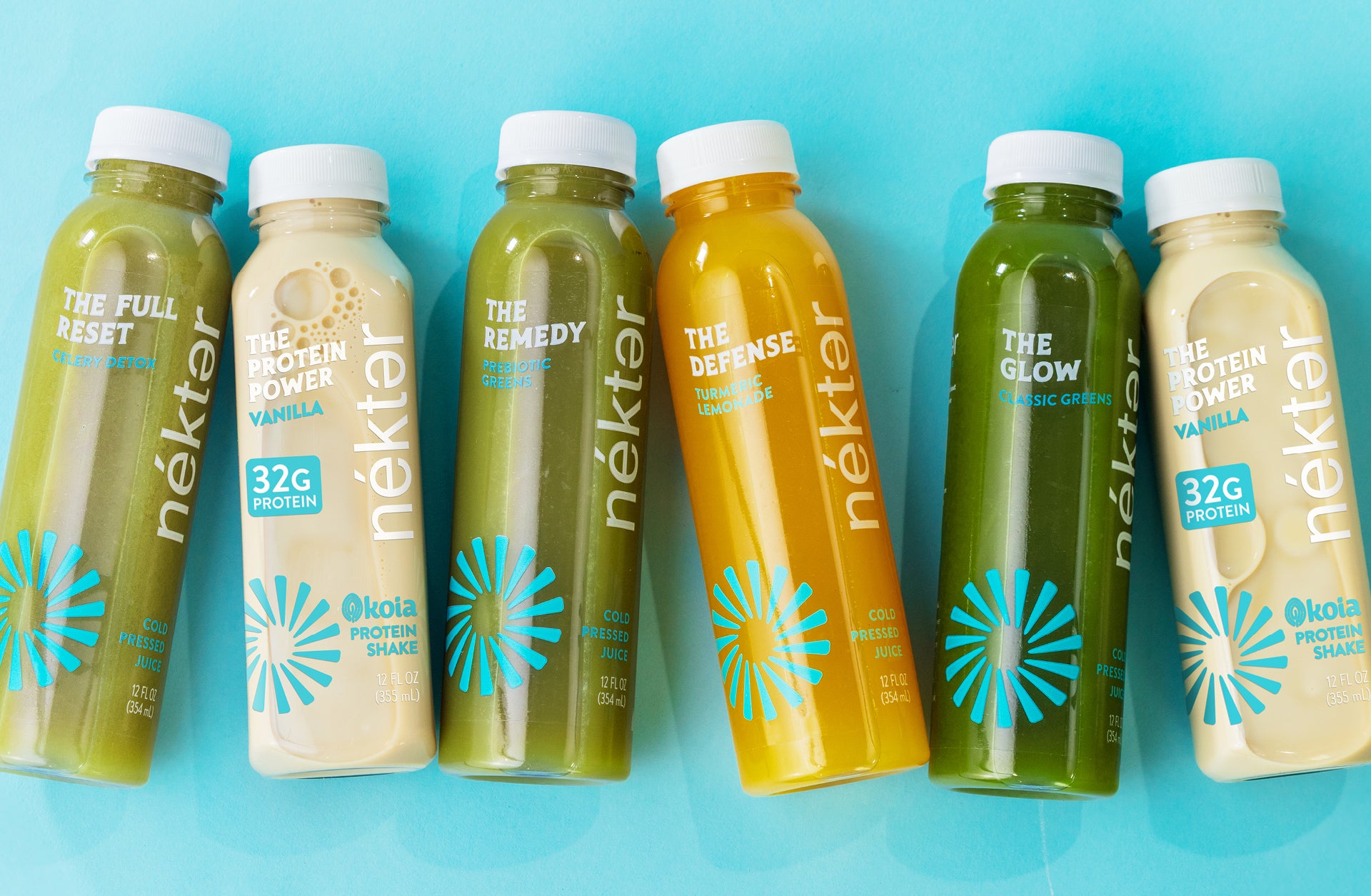 Row of Nektar juice bottles on a blue background