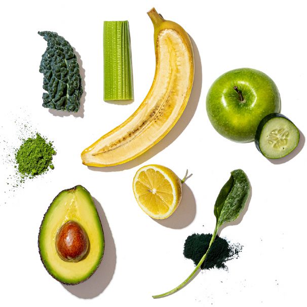 Collection of green fruits, vegetables, and superfoods on a white background