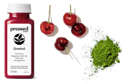 Bottle of 'Pressed' Unwind tea with cherries and green powder on a white background